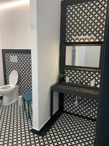 a bathroom with a toilet and a mirror at Rosalia Homestay - Levante Apartment in Cinisi