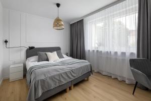 Posteľ alebo postele v izbe v ubytovaní Apartamenty Rodzinne Zdrojowe
