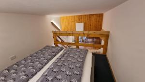a bedroom with a bunk bed in a room at La Casa Degli Orsi - presso Sussy Residence in Falcade
