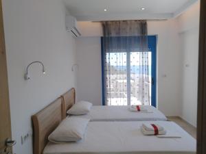 um quarto com 2 camas e uma janela em Mikro Nisi Studios em Agios Nikolaos