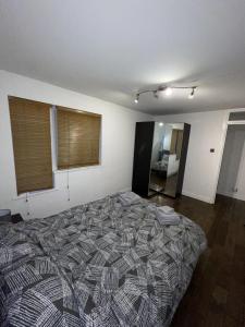 a bedroom with a large bed in a room at Beautiful apartment right off of Broadway Market in London