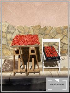 a table with a bunch of red peppers on it at Atelier House 69 in Trappeto