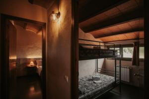 a room with two bunk beds and a hallway at Subirana Rural in Les Llosses