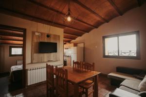 a kitchen and dining room with a table and chairs at Subirana Rural in Les Llosses