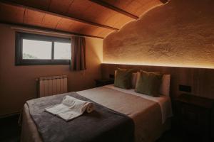 a bedroom with a bed with a towel on it at Subirana Rural in Les Llosses