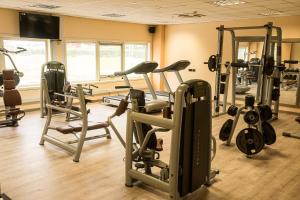 a gym with several treadmills and exercise bikes at Heliconia Park Port Harcourt Hotel and Suites in Port Harcourt