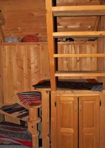 a sauna with wooden cabinets and a stool at Koliba Nazif Softić in Fojnica