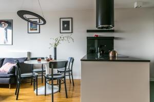 a kitchen and dining room with a table and chairs at Apartament Złota in Warsaw