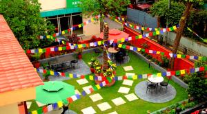 a courtyard with multicolored flags in a building at Hotel Blue Horizon in Kathmandu