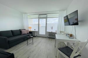 a living room with a couch and a table at Apartment Diekblk mit Pool in Dahme