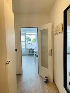 an empty room with a hallway with a door and a mirror at Apartment Diekblk mit Pool in Dahme