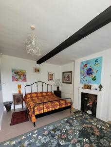 a bedroom with a bed and a fireplace at Art House B & B in Raglan