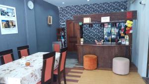 a restaurant with a table and a counter with a bar at Fueangfu Home Hostel in Chaweng