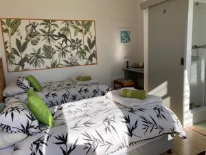a bedroom with two beds and a painting on the wall at Waves Of Witsand in Witsand