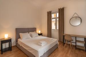 sypialnia z łóżkiem i lustrem na ścianie w obiekcie Charming 3bd apt. close to metro w Atenach