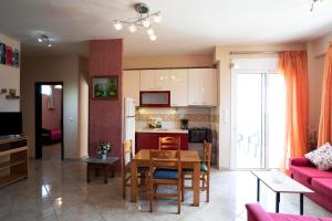 a kitchen and living room with a table and a couch at House in Eleusis (Elefsina) a city close to Athens in Elefsina