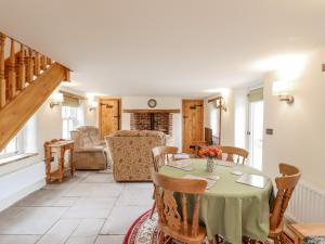 a dining room with a table and chairs at Postbox Cottage in Thetford