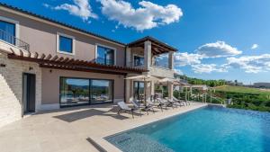 a villa with a swimming pool and patio at Villa Faloniga by Villas Holiday in Vranje Selo