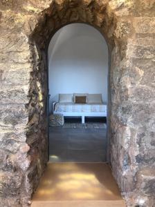 A bed or beds in a room at Dammuso Rekhale con vista mare