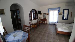 a living room with a couch and a table at Aegean Star Hotel in Karavostasi
