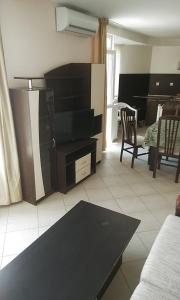 a living room with a tv and a table at Apartment 54 Ryor in Sunny Beach