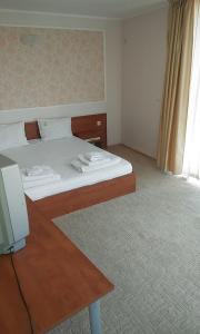a bedroom with a bed and a desk with a television at Apartment 54 Ryor in Sunny Beach