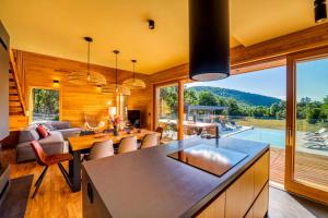 a kitchen and living room with a large window at Villa Lovelos in Lovinac
