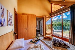 a room with a bed and a large window at Villa Lovelos in Lovinac +37 photos