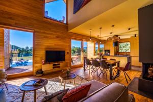 a living room with a couch and a table and a television at Villa Lovelos in Lovinac