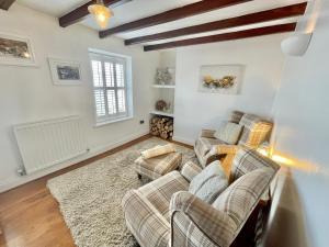 a living room with two couches and a rug at Harbourside in Staithes +43 photos