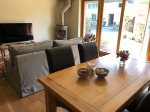 a living room with a wooden table and a couch at Glebe Farm B&B in Kingsbridge
