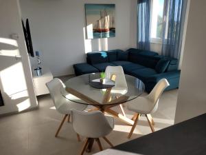 a living room with a glass table and chairs at Haus Dalmatia with heated Pool in Bibinje