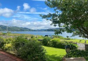 a view of a body of water from a yard at Findhorn Upper Apartment in Kames