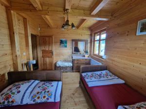 a log cabin with a bed and a sink in it at Zawoja hrabkowa Jastrzębowka in Zawoja