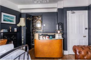 a kitchen with a counter in the middle of a room at Room at the Inn in Lyme Regis