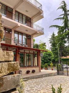 a large house with a balcony and a patio at Central Kvareli in Kvareli