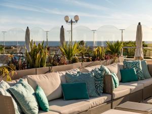 a row of pillows on a couch on a patio at Hotel Quinta do Lago in Quinta do Lago