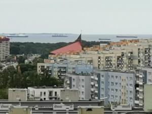 a view of a city with buildings and the ocean at MustSEA Gdańsk Apartments with underground parking in Gdańsk