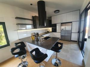 a kitchen with a counter and stools in a room at House G in Supetar