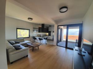 a living room with a couch and a table at House G in Supetar
