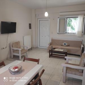 a living room with a couch and a table at ARETI4 in Petalidi