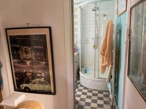 a bathroom with a picture of a car on the wall at Comfy Cosy Room Tv fridge microwave in Upton