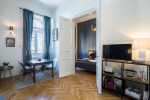 a living room with a bed and a table in a room at Double Blue Apartment in Budapest Downtown in Budapest