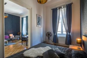 a bedroom with a bed and a living room at Double Blue Apartment in Budapest Downtown in Budapest
