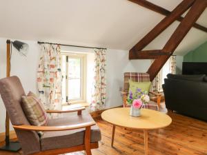 a living room with a couch and a table at Joiners Cottage in York