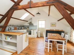 a kitchen with a wooden table and a wooden floor at Joiners Cottage in York