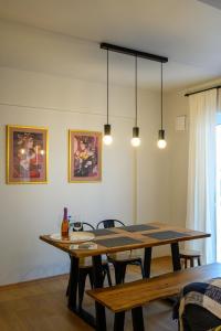 a dining room with a wooden table and chairs at Plato 88 in Kalamata