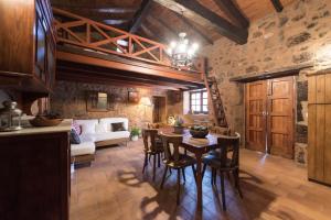 a living room with a table and chairs and a couch at Montsant in Teror