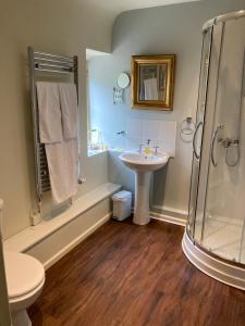 a bathroom with a sink and a shower at Maplestone in Shepton Mallet