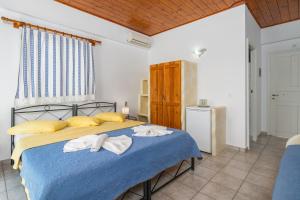 A bed or beds in a room at Apollon Rooms